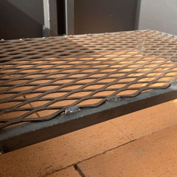 A charcoal grate made for a Santa Maria grill firebox.
