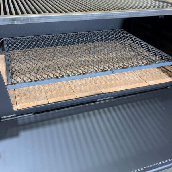 A grate that allows embers to be elevated above ash.
