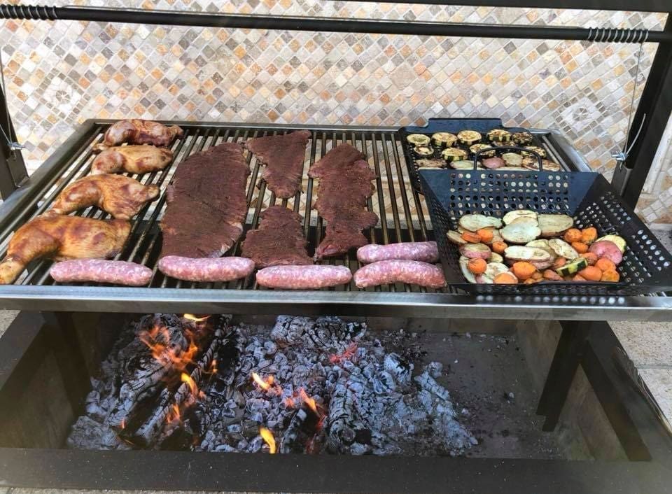 36 x 24-inch Santa Maria BBQ Grill Loaded with steak, vegetables, and sausage