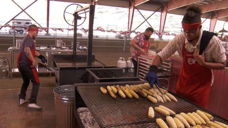 Derrick Fox Grilling Ribeye while Gabriel Lewis is grilling corn on Gaucho Grills